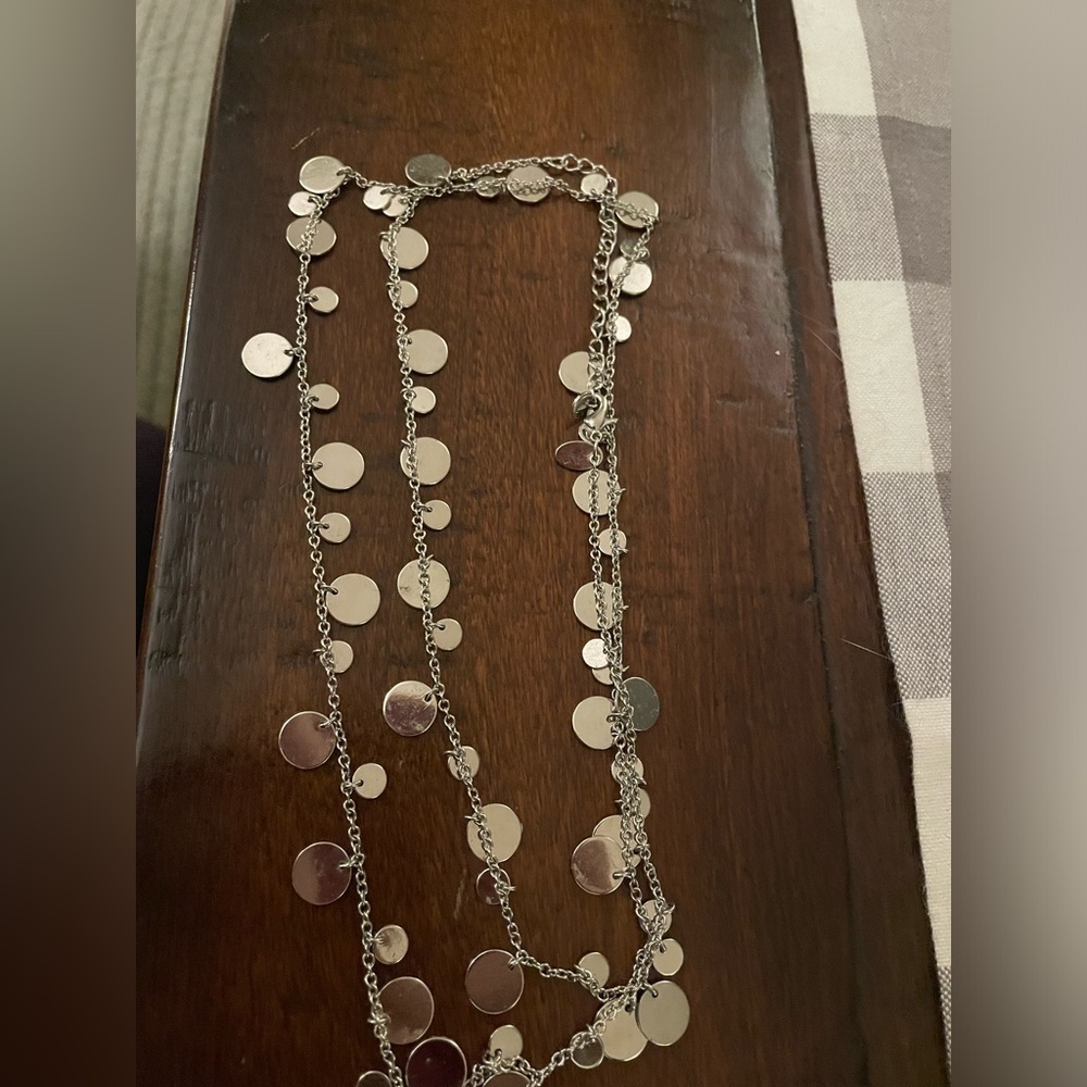 Lia Sophia long silver disc necklace.